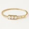 14k yellow gold diamond bangle with emerald cut design