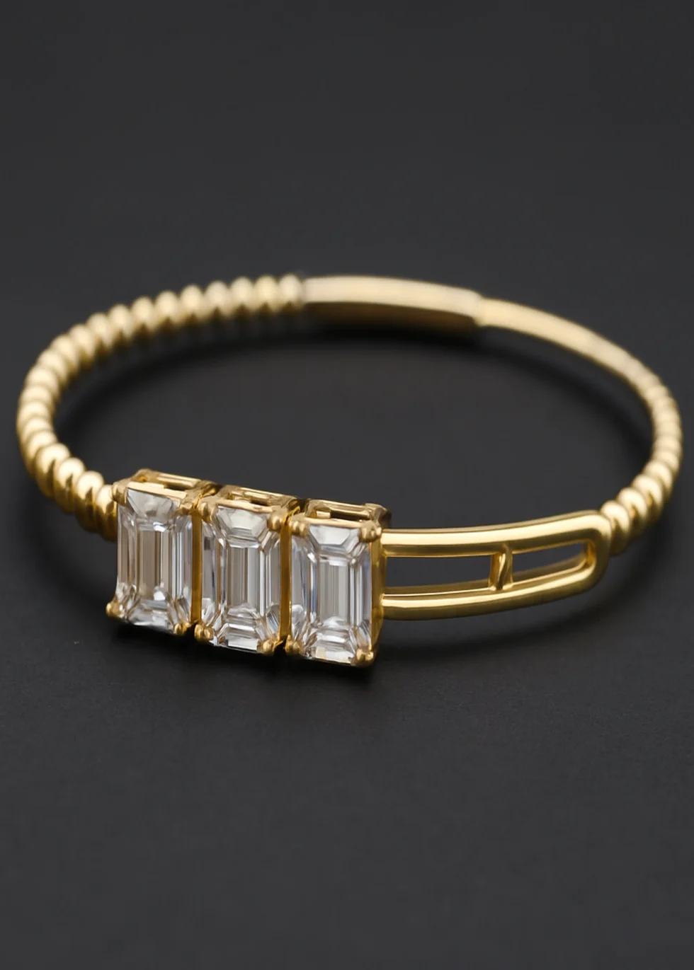 14k yellow gold diamond bangle with emerald cut design