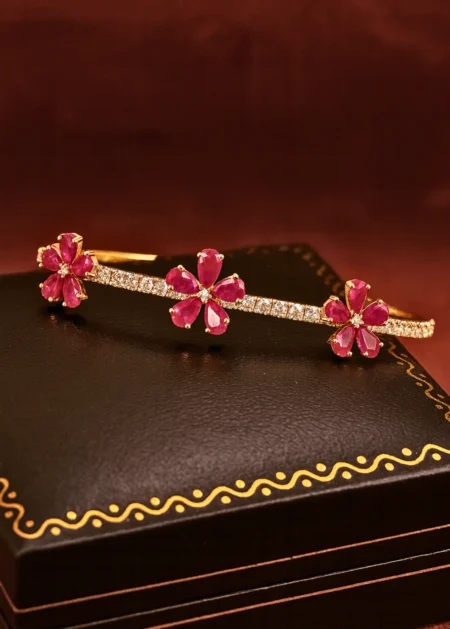 14k yellow gold ruby bangle with diamond accents